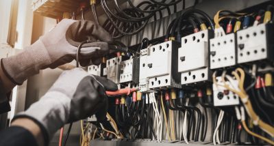 Electrician Working on Circuit Panel