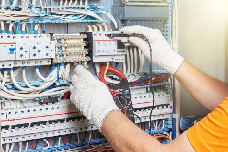 Electrician Working on Circuit Panel